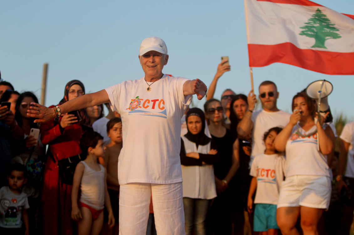 Mona Khalil, a Lebanese conservationist who died on Friday after being wounded in an Israeli strike on her home on Lebanon's southern coast, gestures during a event of releasing baby sea turtles in Mansouri village near Tyre city, south Lebanon, July 31, 2019. (AP)
