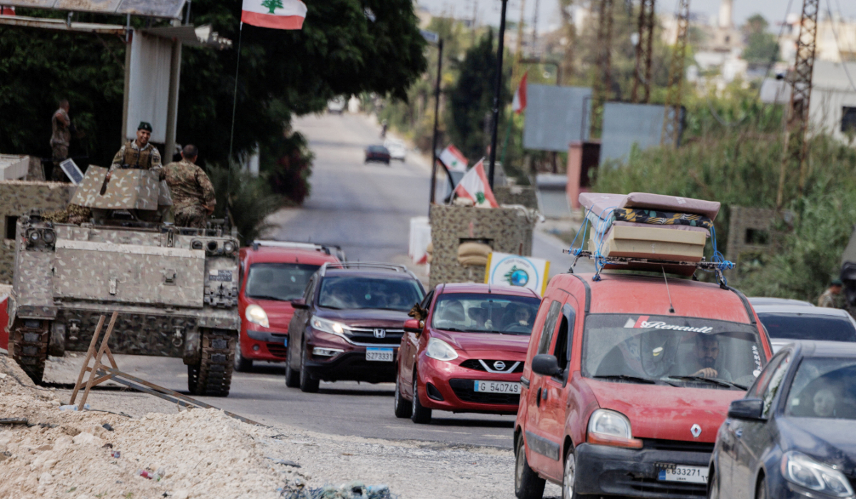 Lebanon's Central Bank called on the US and allies 'to guarantee the protection of civilians and Lebanese official institutions.'Displaced people make their way back to their home in southern Lebanon on Sunday. Israeli says that its troops would remain in south Lebanon 'as long as necessary.' (Reuters)