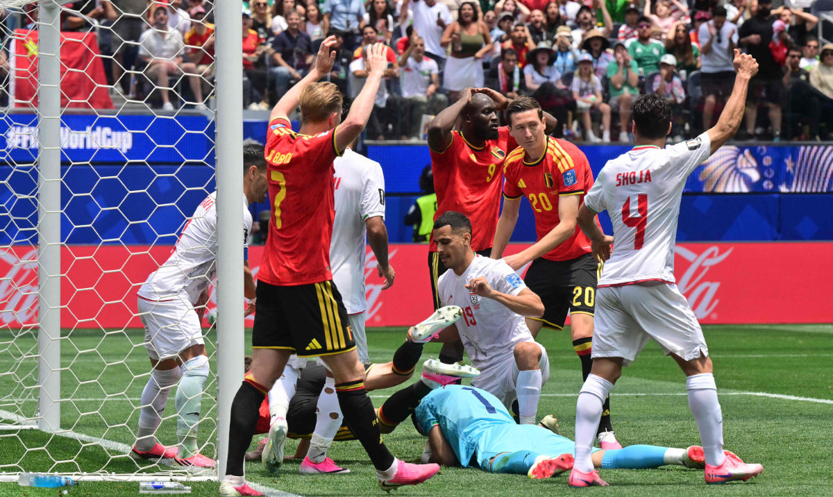 Iran's goalkeeper #01 Alireza Beiranvand makes a save past Belgium's defender #05 Maxim De Cuyper during the 2026 World Cup Group G football match between Belgium and Iran at the Los Angeles Stadium in Inglewood on June 21, 2026. (AFP)