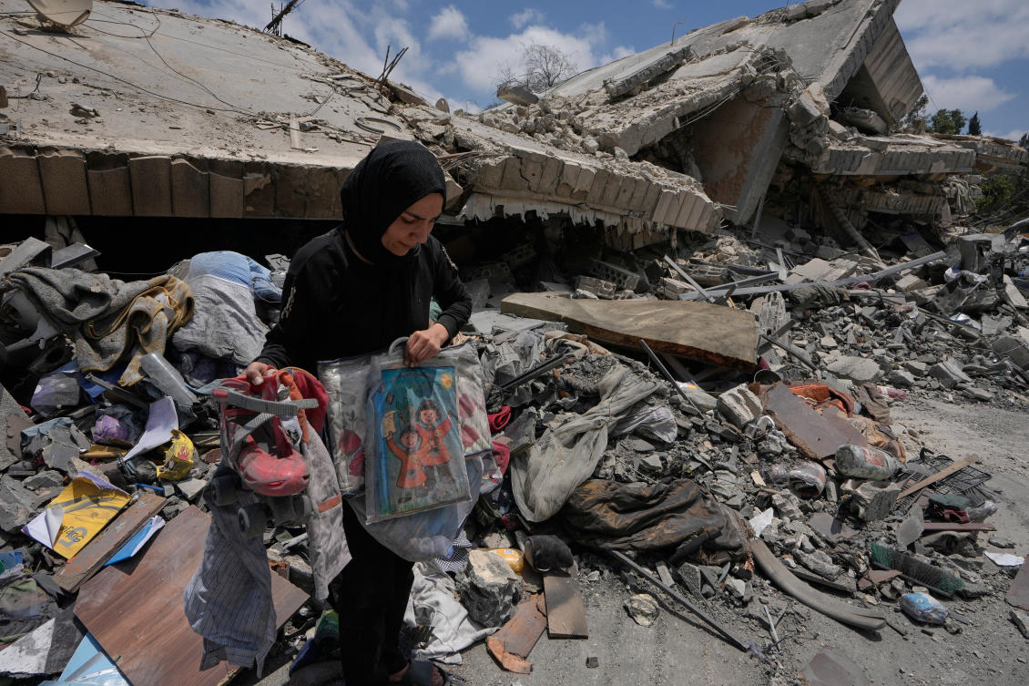 A woman collects her kids toys and belongings from her destroyed house following a ceasefire between Israel and Hezbollah in the village of Maifadoun, southern Lebanon, Monday, June 22, 2026. (AP)