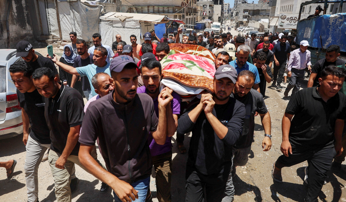 Mourners carry the body of Palestinian Raghad Ashour, who was killed in an Israeli strike on a vehicle, according to medics, during his funeral in Gaza City, June 22, 2026. (REUTERS)