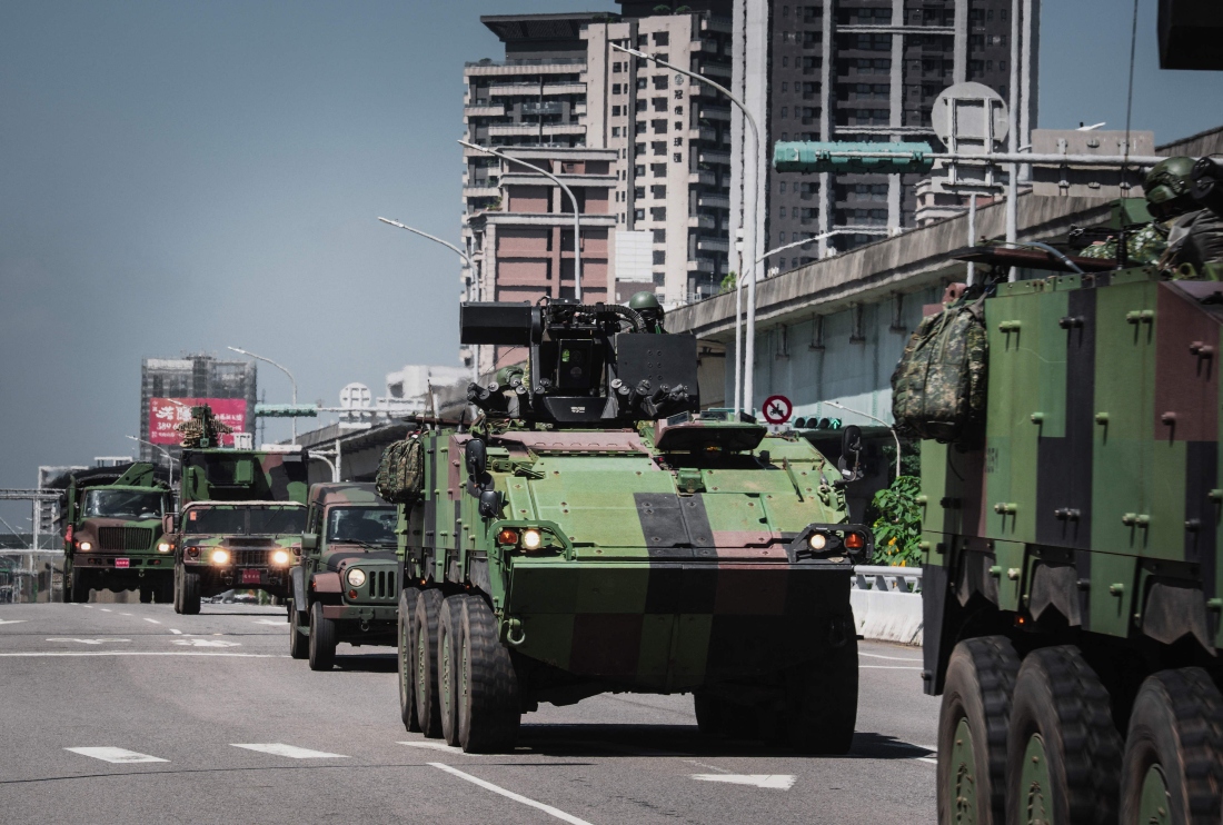A row of armoured military vehicles driving along the highway in Taoyuan, Taiwan. (AFP)