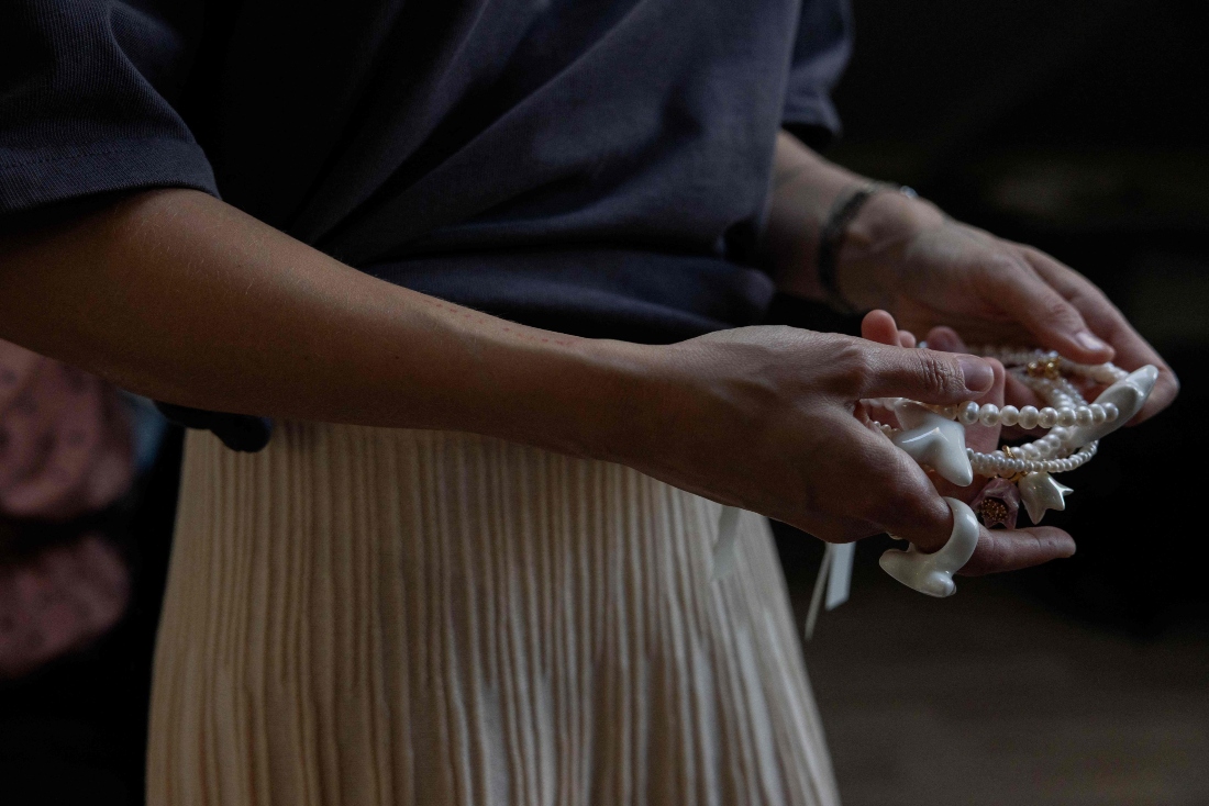 Ukrainian founder of Tsvite Teren company Olga Ostapenko holds jewelry in Kyiv, Ukraine. (AFP)