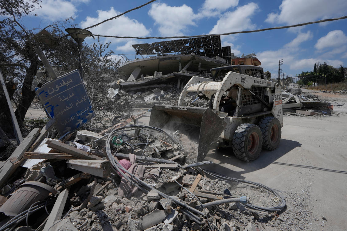 A worker uses a skid loader to clear the rubble from the roads of the southern village of Maifadoun, following a ceasefire between Israel and Hezbollah, Lebanon, Monday, June 22, 2026. (AP Photo/Mohammed Zaatari)