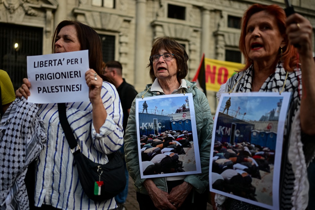 People take part in a flash mob entitled "In the same boat" to protest against the detention and treatment by Israel of activists participating in the Global Sumud Flotilla in Mila, Italy. (AFP)