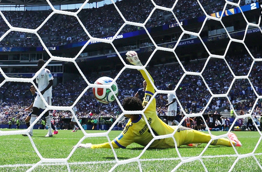 Bosnia and Herzegovina's Ermin Mahmic scores their third goal past Qatar's Mahmoud Abunada. (Reuters)