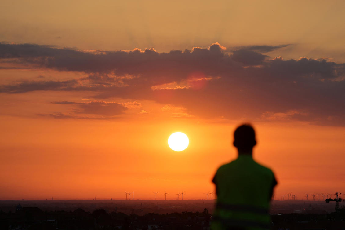 A man watches the rising sun in Berlin, Germany, June 25, 2026. (REUTERS)