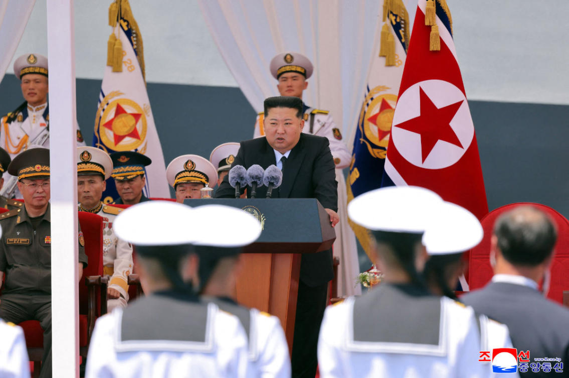 This picture taken on June 23, 2026 and released by North Korea's official Korean Central News Agency (KCNA) on June 24, 2026 shows North Korean leader Kim Jong Un (C) delivering a speech during a commissioning ceremony of the new-type multi-mission destroyer Choe Hyon at Nampo port in North Korea. (Photo by KCNA via KNS / AFP)