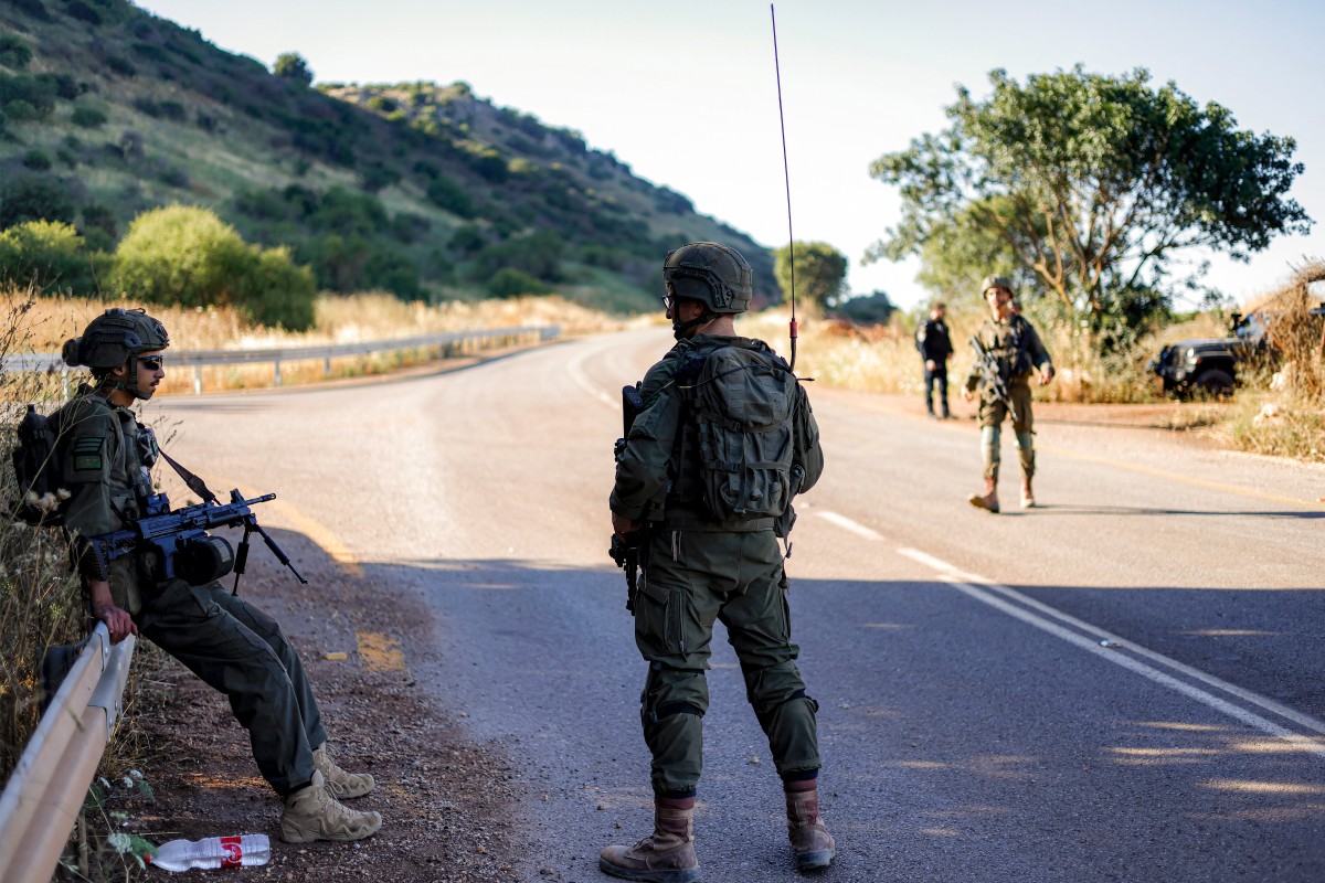 Israeli army soldiers patrol along the northern road near Moshav Margaliot in the Upper Galilee bordering Lebanon. (AFP)
