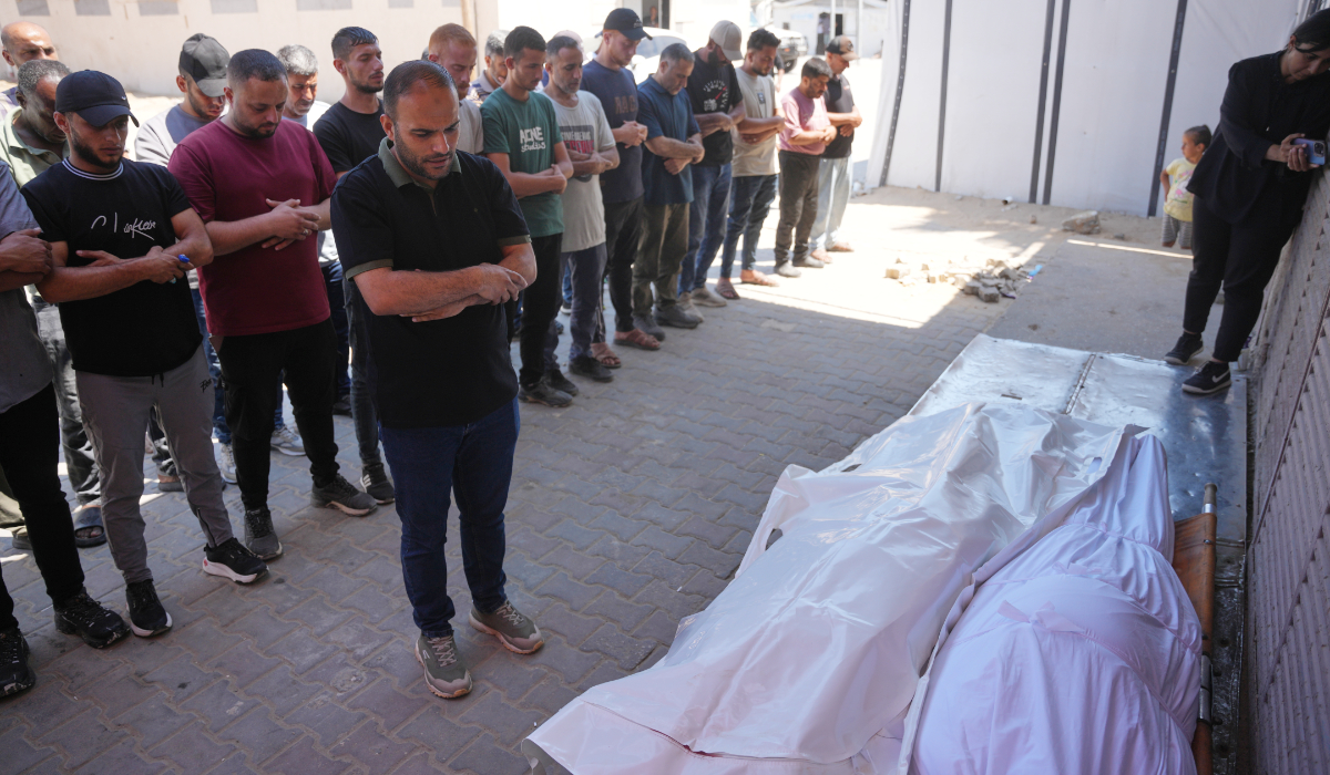 Mourners pray over the bodies of Palestinian men who were killed in an Israeli airstrike in the Maghazi refugee camp on Friday, during their funeral in Deir al-Balah, Gaza Strip, Saturday, June 27, 2026. (AP)