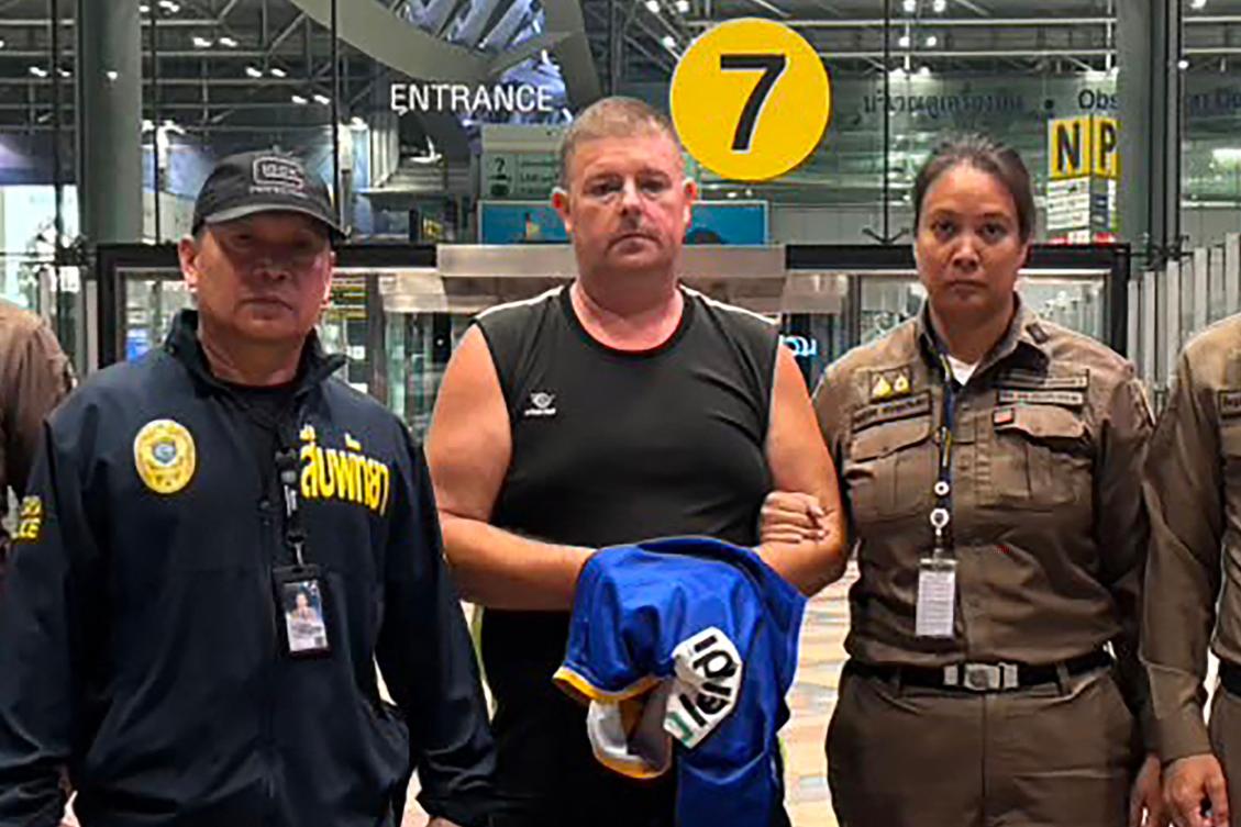 Above, police officers with Australian man Simon Peter Carman at Suvarnabhumi International Airport in Bangkok on June 27, 2026 after he was arrested in the suspected murder of a 17-year-old Thai girl in Pattaya. (Pattaya City Police Station/AFP)
