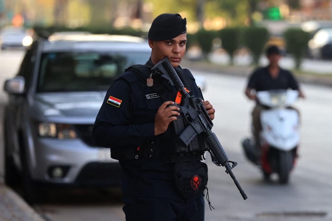 An Iraqi security personnel stands guard along a street in Baghdad on Sunday. (AFP)