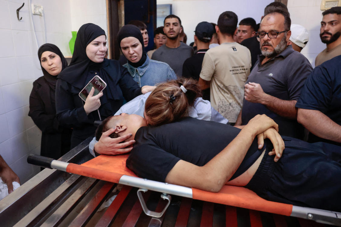 The mother and other relatives of a 15-year-old Palestinian boy killed by Israeli forces during a raid mourn over his body at a hospital in Ramallah in the Israeli-occupied West Bank. (REUTERS)