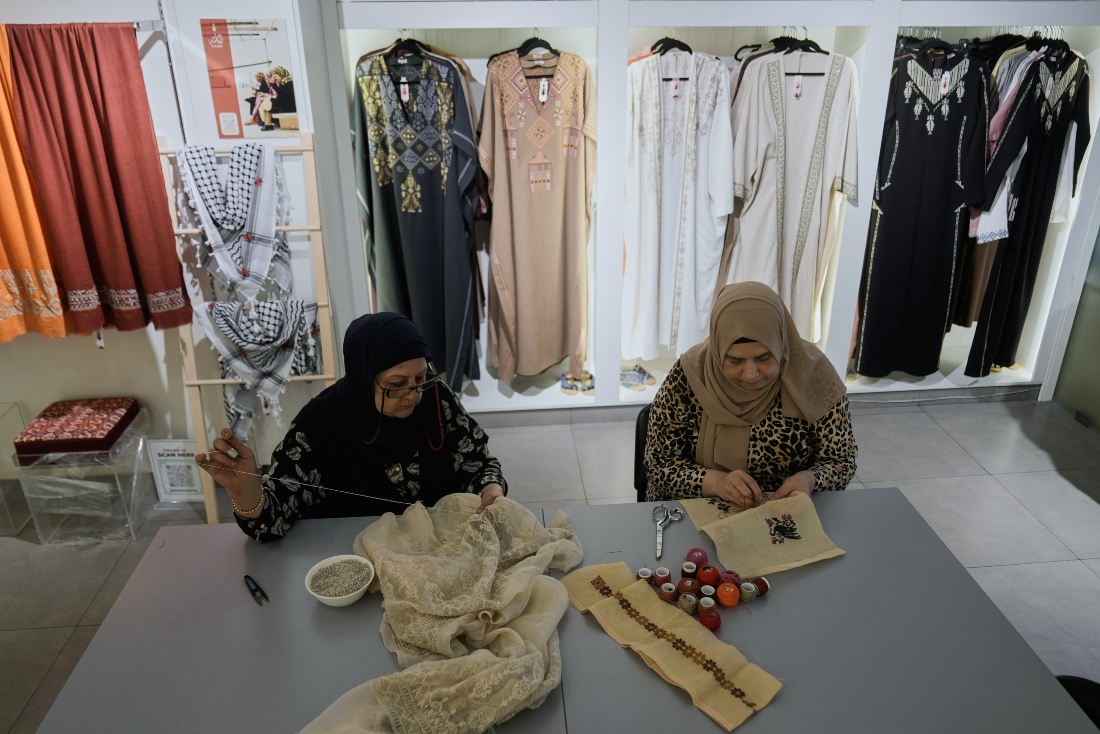Palestinian weavers Rula Barakeh and Samira Nasser work on handmade embroidered pieces at the Inaash Association embroidery workshop in Beirut, Lebanon. (AP)