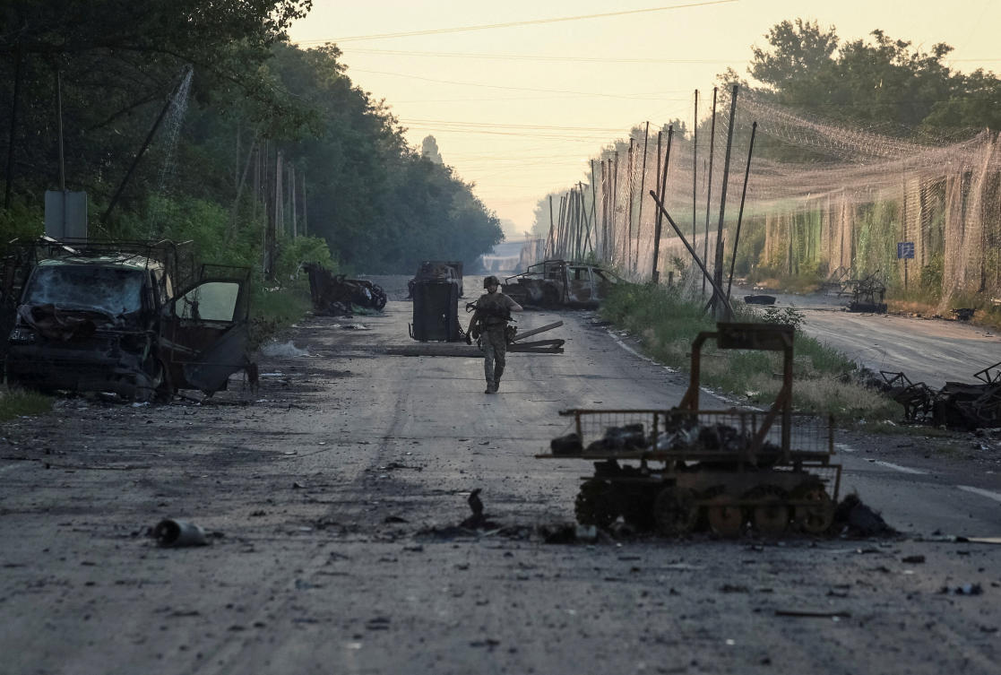 FILE PHOTO: A serviceman of the consolidated Brigade 'Khyzhak' of the Ukrainian Patrol Police Department walks along a road near anti-drone nets and destroyed military vehicles as he takes part in a mission to protect a road from Russian drones between frontline towns of Druzhkivka and Kostiantynivka, amid Russia's attack on Ukraine, in Donetsk region, Ukraine June 24, 2026. (Reuters)