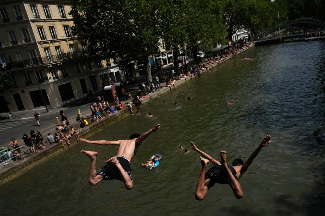 Parisians bath in the Canal Saint-Martin in Paris, as the national weather service, Meteo France, placed 54 departments, about half the country, under a red heat wave alert, on Jun. 23, 2026. (AP/File)