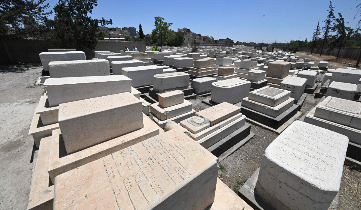 Syrian workers are seen inside the Jewish cemetery in Damascus on June 30, 2026. (AFP)