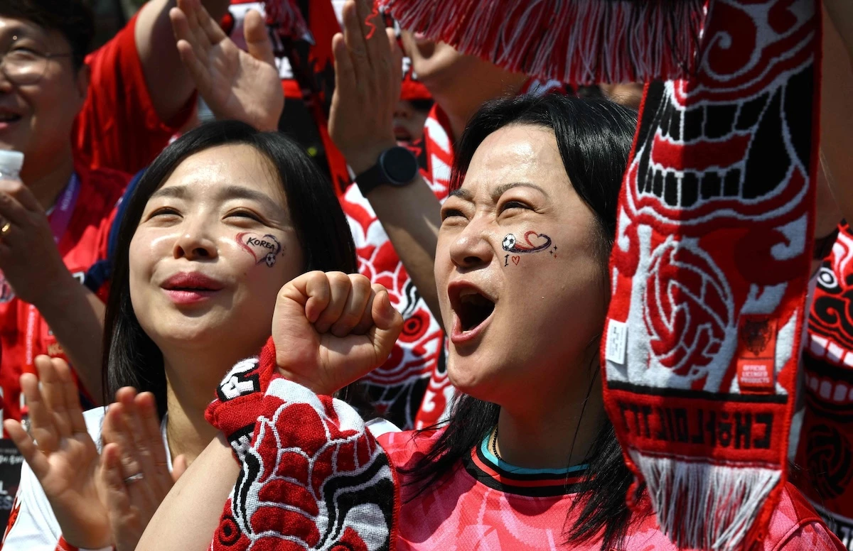 South Korean fans cheer as they watch the 2026 World Cup football match between South Korea and the Czech Republic on big screens in Seoul on June 12, 2026. (AFP)
