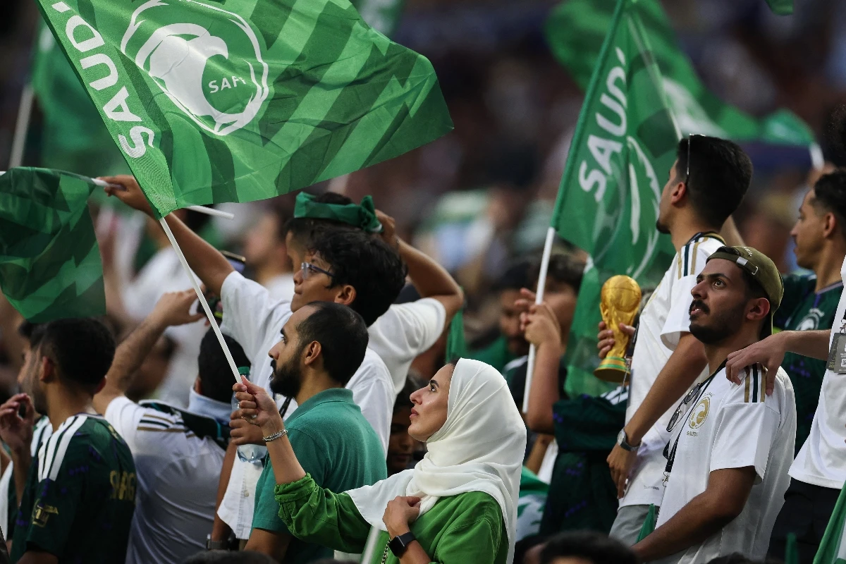 Fans cheer on in Miami waving the Saudi flag. (AFP)