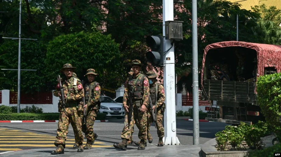 Myanmar security forces patrol a street during a silent strike, in Yangon Feb. 1, 2024. (AFP)