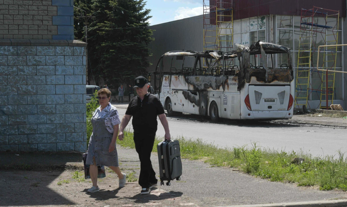 A view shows the site of a drone strike on a bus in the settlement of Yenakiyeve in the Donetsk region, Russian-controlled Ukraine, on June 3, 2026, amid the ongoing Russian-Ukrainian conflict. (AFP)