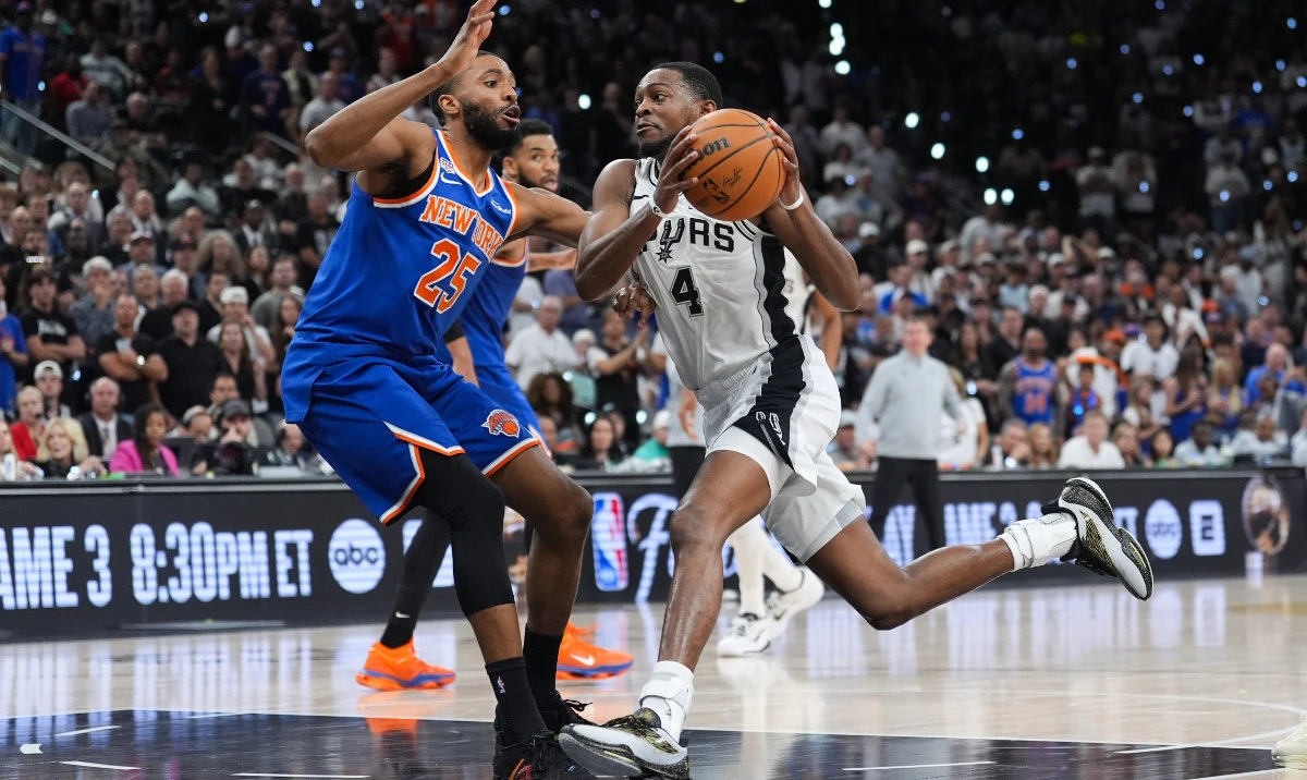 San Antonio Spurs guard De'aaron Fox (4) drives as New York Knicks guard Mikal Bridges (25)- defends during the first half of Game 2 of the NBA Finals basketball series, Friday, June 5, 2026, in San Antonio. (AP)