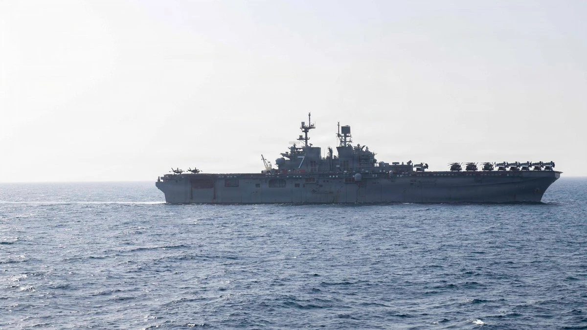 Above, the USS Tripoli transits the Arabian Sea as it supports the ongoing US blockade against Iran. (X: @CENTCOM)