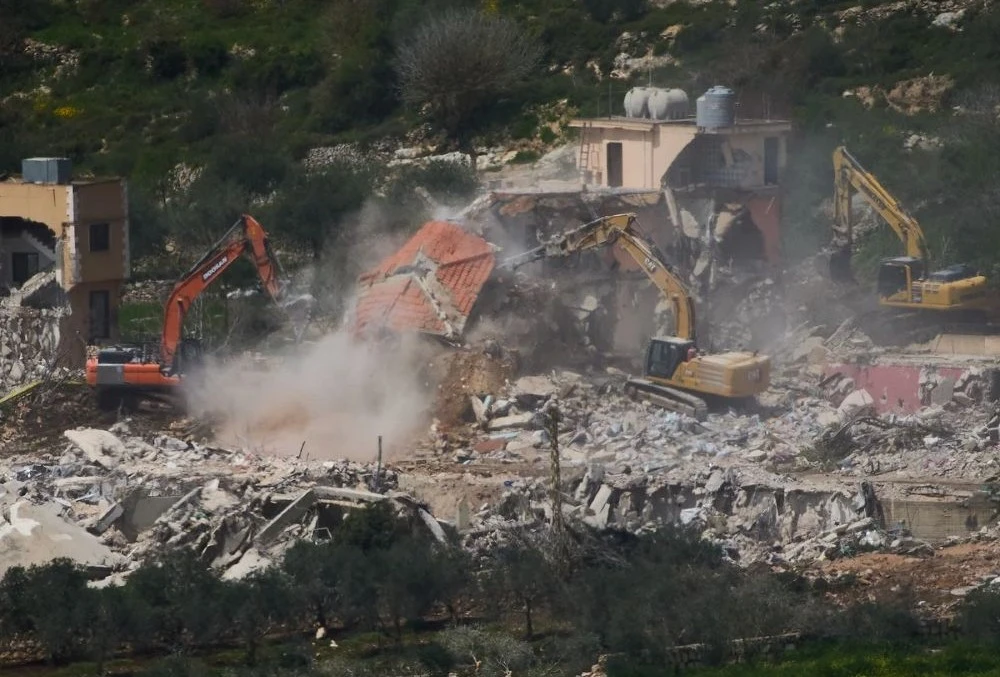 Bulldozers demolishing homes in southern Lebanon, as seen from northern Israel. (AP Photo)