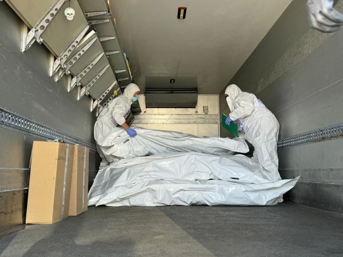 A photo dated August 2024, shows International Red Cross representatives checking body bags containing remains of servicemen during an exchange of bodies in an undisclosed location in Sumy region. (AFP)