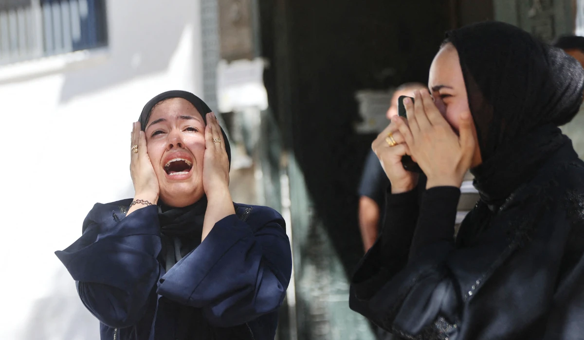 Displaced Palestinian women mourn the death of a man killed in an Israeli airstrike, prior to being taken for burial from the Al-Shifa Hospital in Gaza City, on June 18, 2026. (AFP)