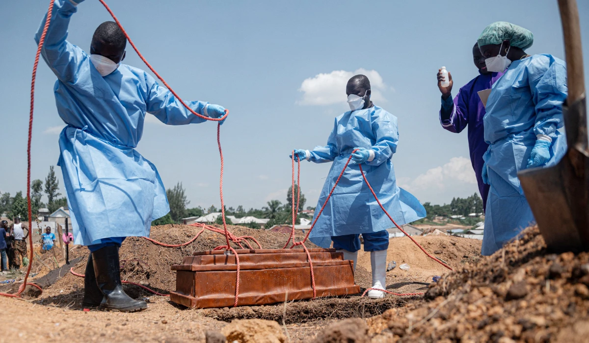 Teams from the International Federation of the Red Cross and Red Crescent Societies prepare for burial at Mbiyo cemetery the body of a fourth orphan who died from Ebola virus disease at an orphanage in Bunia, Ituri Province, June 19, 2026. (AFP)