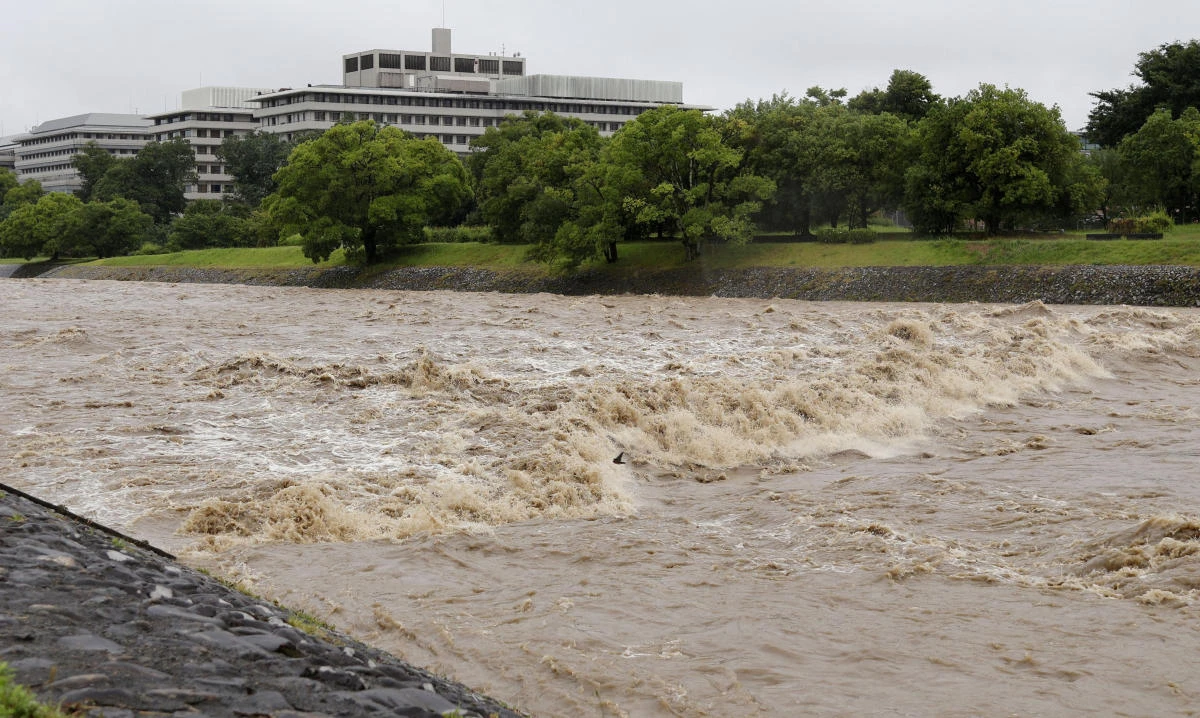 The Kamo River, swollen by heavy rain, flows rapidly in Kyoto, Japan June 26, 2026, in this photo taken by Kyodo. (Reuters)
