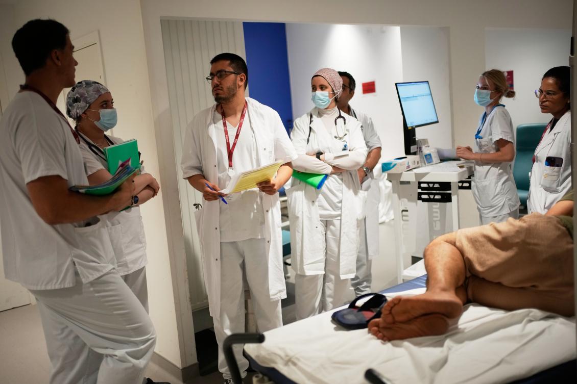 Doctors and nurses take care of a patient at the emergency department of the Paris-Saclay Hospital, outside Paris, Tuesday June 30, 2026. (AP)