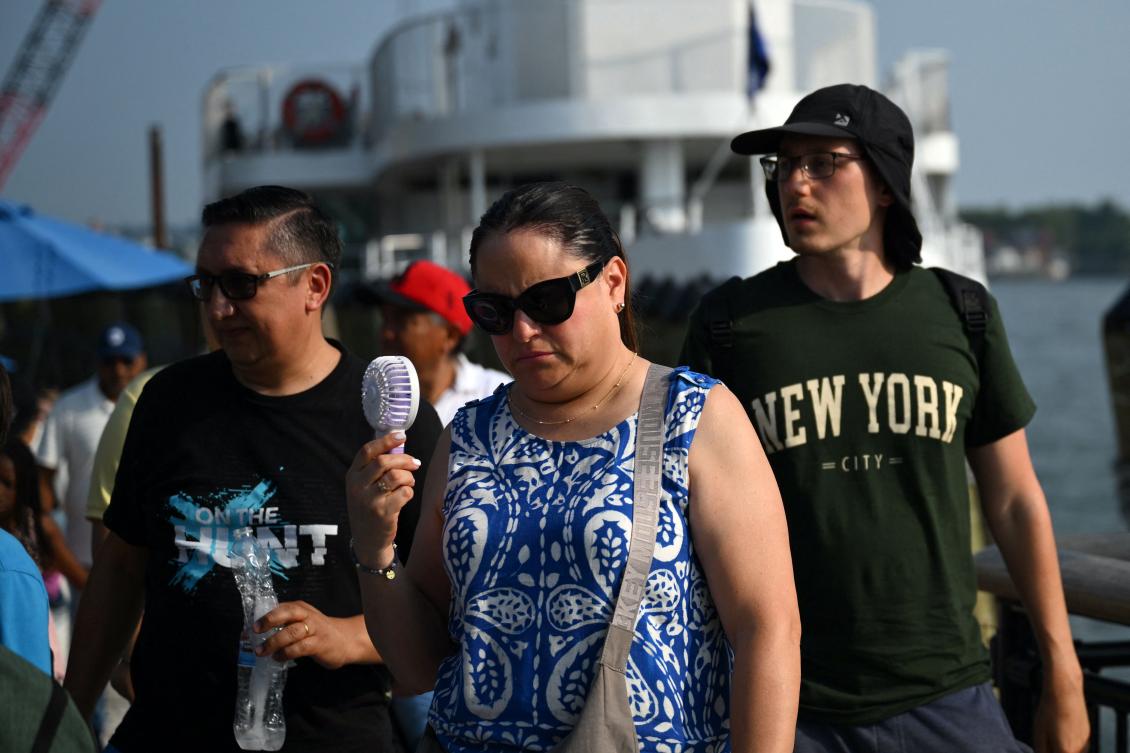 Above, people disembark a ferry at Battery Park during a heatwave in New York on July 1, 2026. (AFP)