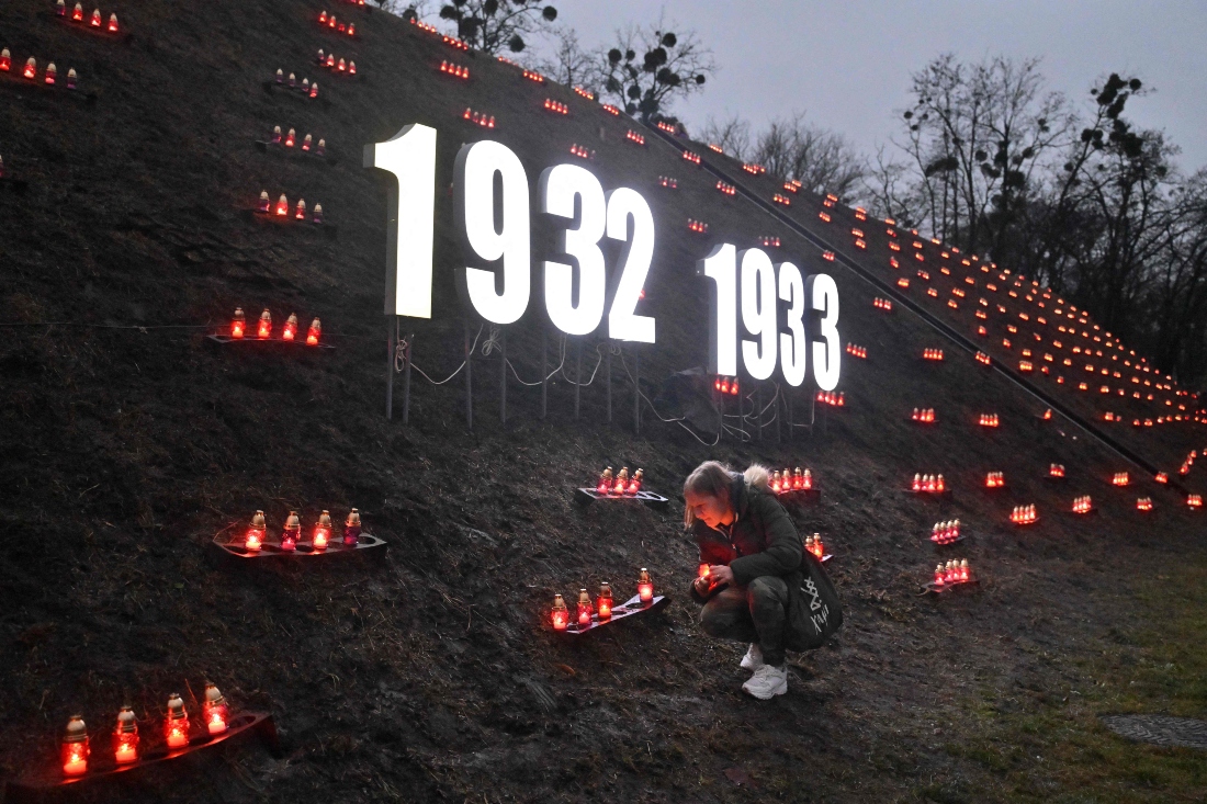 A man lays a candle in tribute to the victims of the famine of 1932-1933 at the National Museum of the Holodomor-Genocide in Kyiv, Ukraine. (AFP)