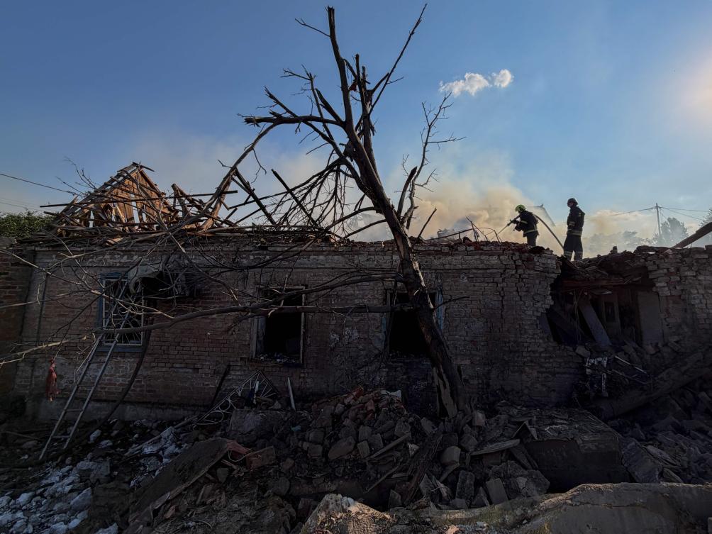 Ukrainian rescuers work to extinguish a fire at a damaged house following an airstrike in Zaporizhzhia on Jun. 30, 2026. (AFP)