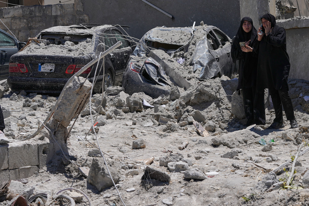 Relatives of missing victims weep, as they gather at the site of destroyed buildings that were hit in an Israeli airstrike in Qannarit village, southern Lebanon, Saturday, June 20, 2026. (AP)