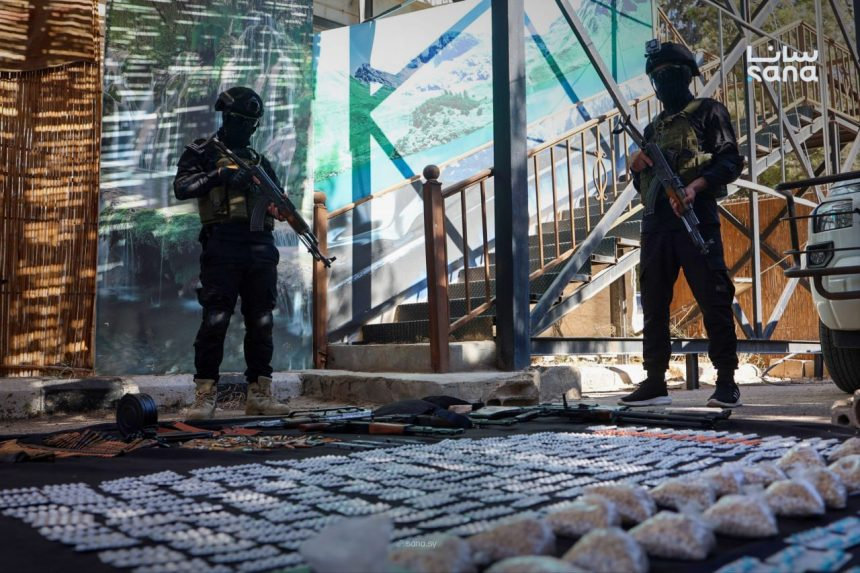 Syrian anti-narcotics personnel display Captagon tablets, narcotic pills, weapons and ammunition seized during a security operation in the town of Nasib, Daraa province. (SANA photo)