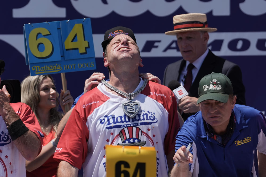 Eating champion Joey Chestnut defends title but blames heat for lower hot-dog tally