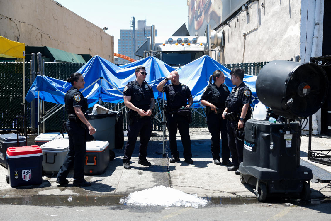 Police officers talk in the street during a summer heat wave, at Coney Island, Brooklyn in New York City, US, July 4, 2026. (Reuters)