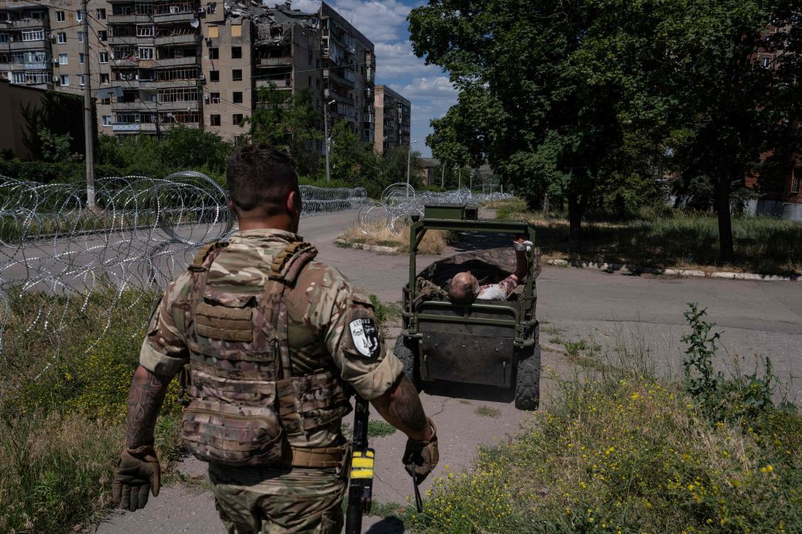 A Ukrainian serviceman stands by a vehicle preparing to evacuate a wounded civilian who was injured by a Russian drone strike in Druzhkivka, Donetsk region, July 3, 2026. (AFP)