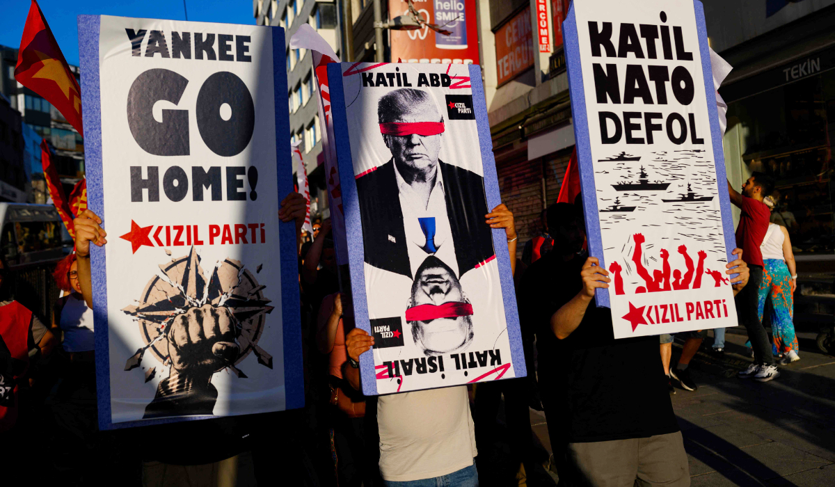 Protestors hold signs and wave flags during an anti-NATO demonstration in Istanbul, ahead of a NATO summit, on July 5, 2026. (AFP)