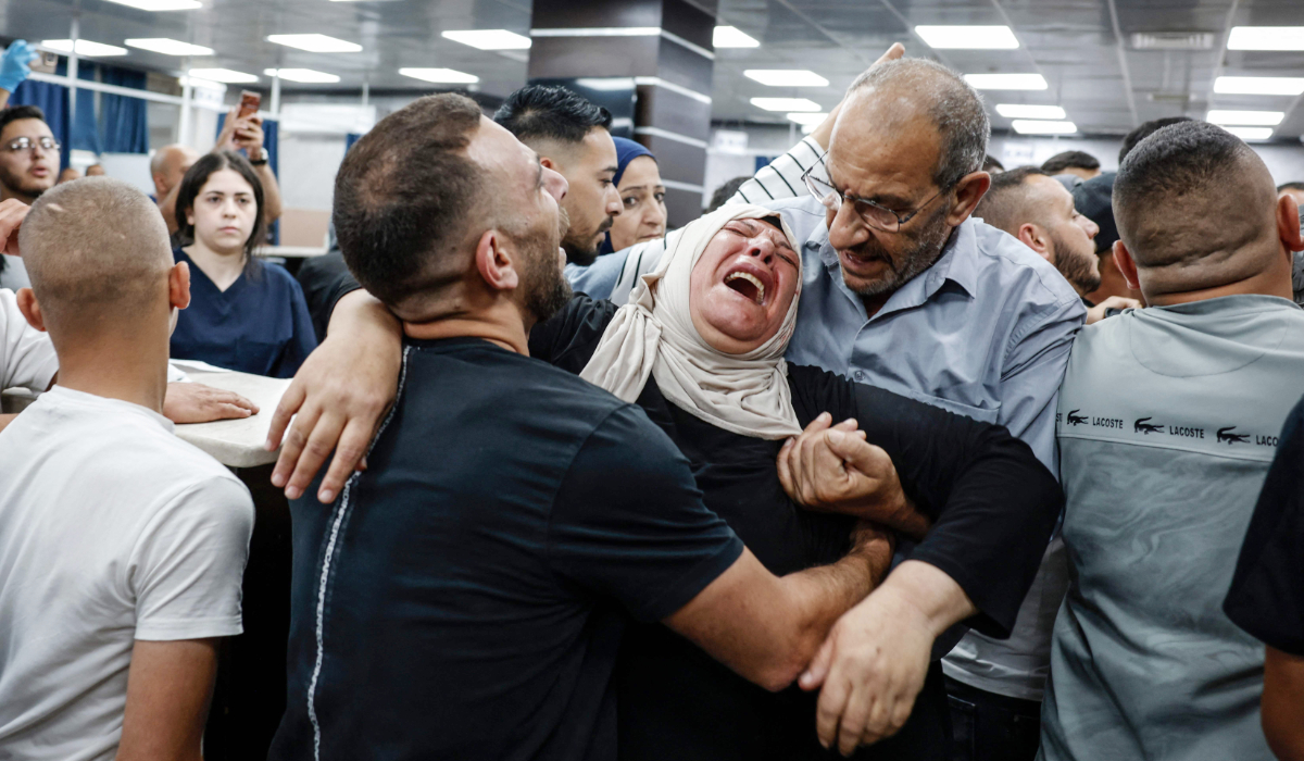 The grandmother of Waleed Nidal Waleed Abu Sneineh, a 16-year-old Palestinian boy reportedly shot dead by Israeli forces, mourns at a hospital in Ramallah, in the Israeli-occupied West Bank, on July 5, 2026. (AFP)