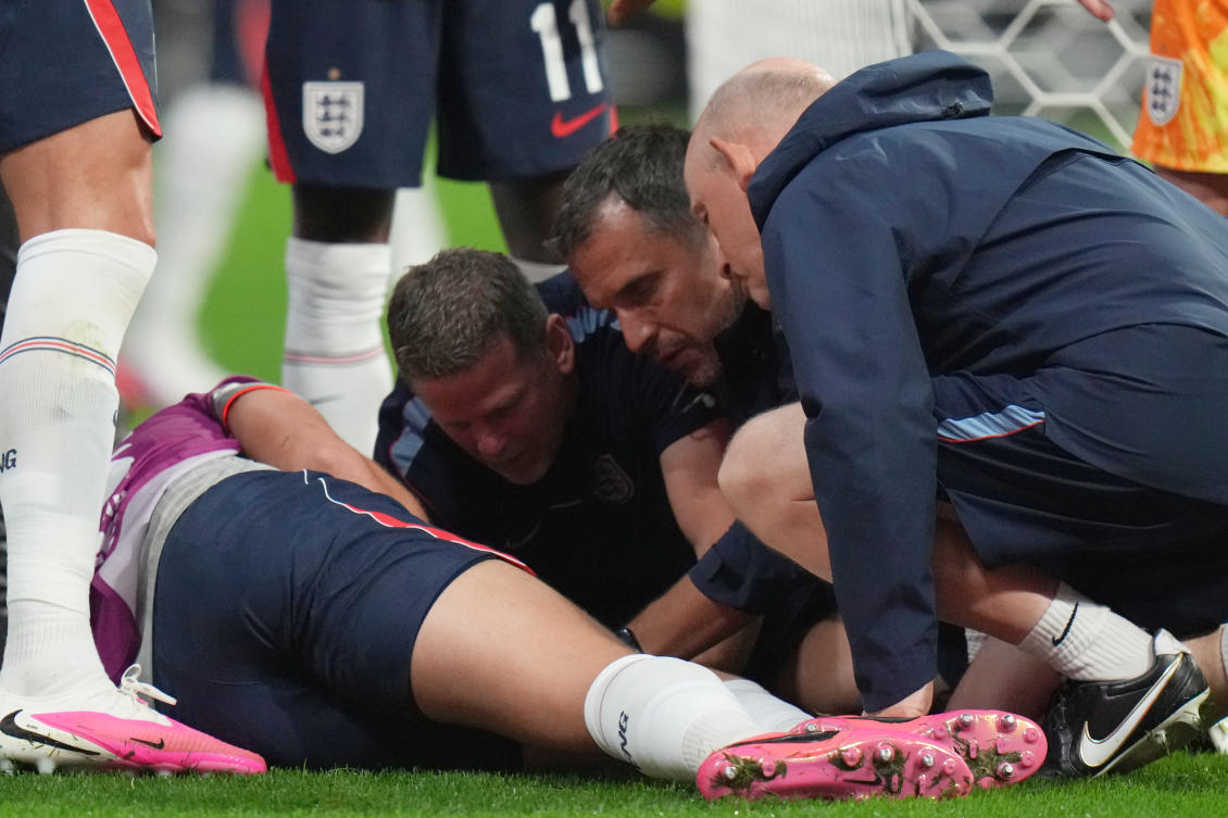England's Jordan Henderson (14) is looked after by training staff following an injury in the postgame celebration in the World Cup round of 16 soccer match between Mexico and England in Mexico City, Sunday, July 5, 2026. (AP Photo/Eduardo Verdugo)