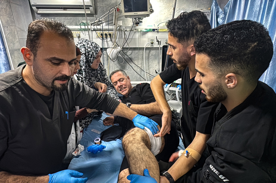 Hussam Abu Safiya, director of the Kamal Adwan Hospital, treated by colleagues for his injuries following an Israeli strike that hit the medical compound in Beit Lahia, northern Gaza. (File/AFP)