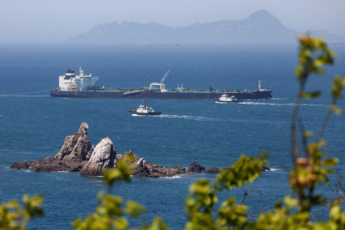 This photo taken on May 8, 2026, shows the crude oil tanker Odessa — carrying UAE crude after passing through the Strait of Hormuz with its Automatic Identification System transponder turned off — being guided by tugboats as it navigates the waters at Daesan port in Seosan, South Korea. (Reuters/File Photo)