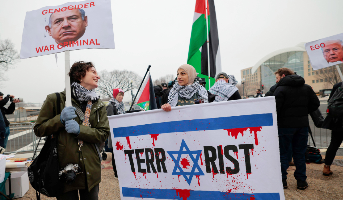 Anti-Trump and pro-Palestine protesters gather outside the Donald J. Trump Institute of Peace on February 19, 2026 in Washington, DC. (AFP)