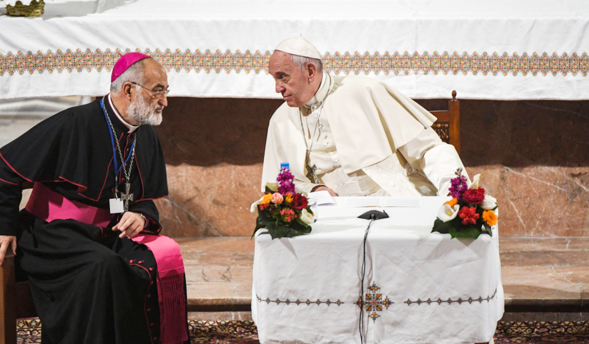 Pope Francis (C) speaks with the Archbishop of Rabat Cristobal Lopez Romero (L) as he meets with members of the clergy at St Peter's Roman Catholic Cathedral in the Moroccan capital Rabat on March 31, 2019, on the second day of the pontiff's two-day visit to Morocco. (AFP)