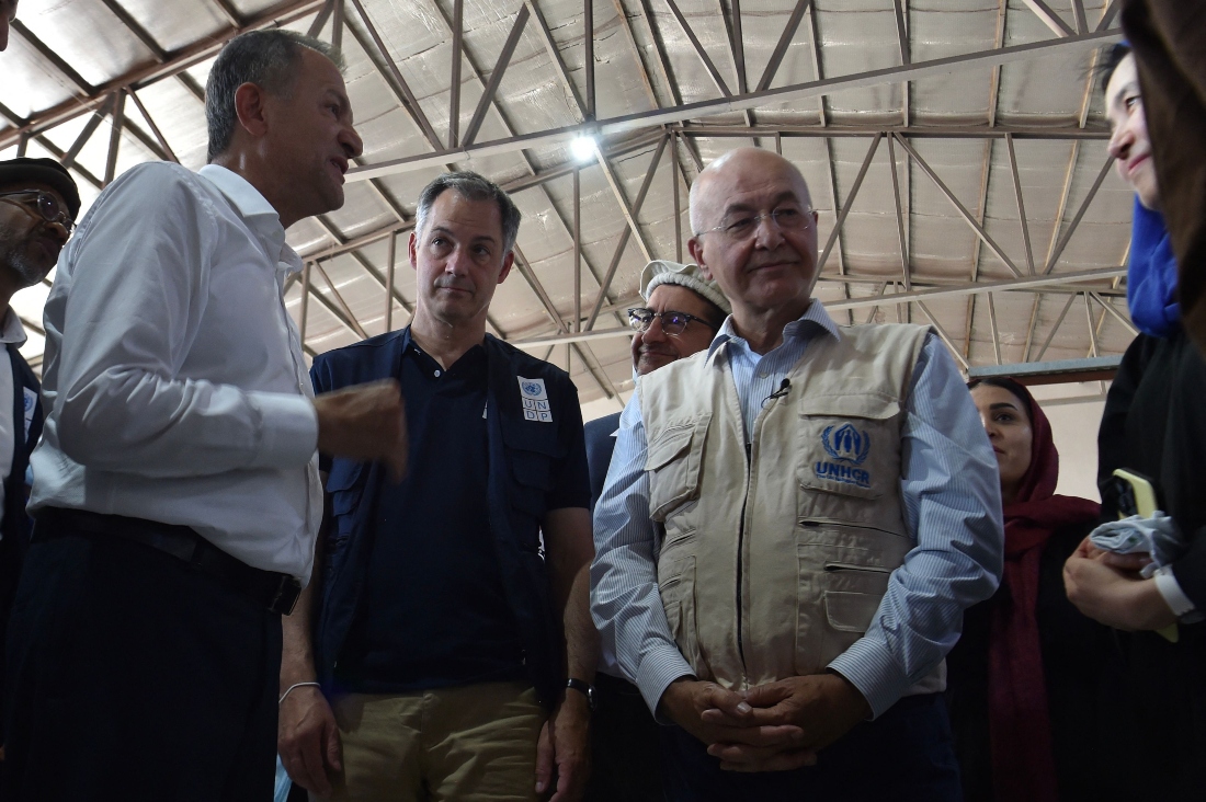UNDP Administrator Alexander De Croo and UN High Commissioner for Refugees Barham Ahmed Salih visit a dry fruit factory employing Afghan returnees in Mazar-i-Sharif, Afghanistan. (AFP)