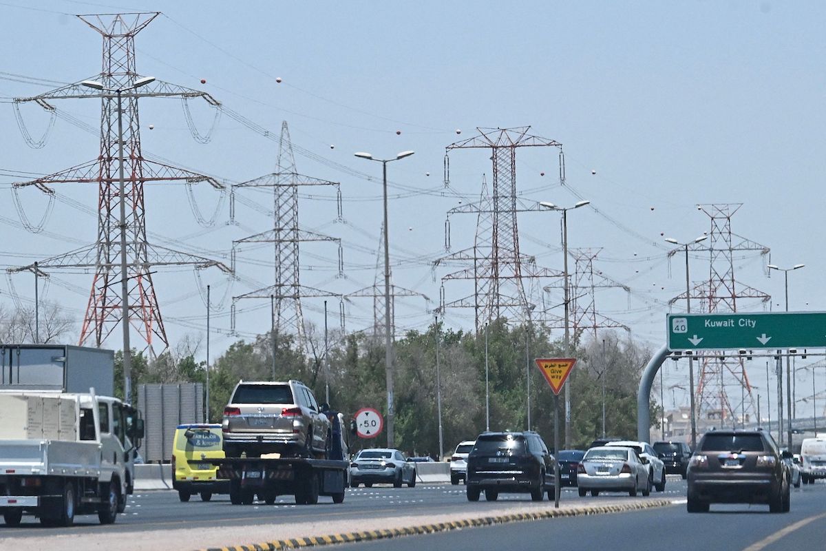 Vehicles drive along a highway on the outskirts of Kuwait City on Wednesday after the country was attacked by Iranian drones and missiles. (AFP)
